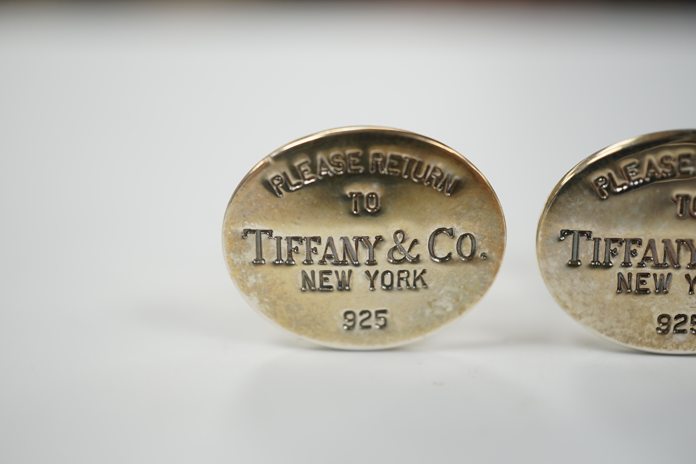 A modern pair of Tiffany & Co gilt 925 oval cufflinks, 19mm, with pouch and box.